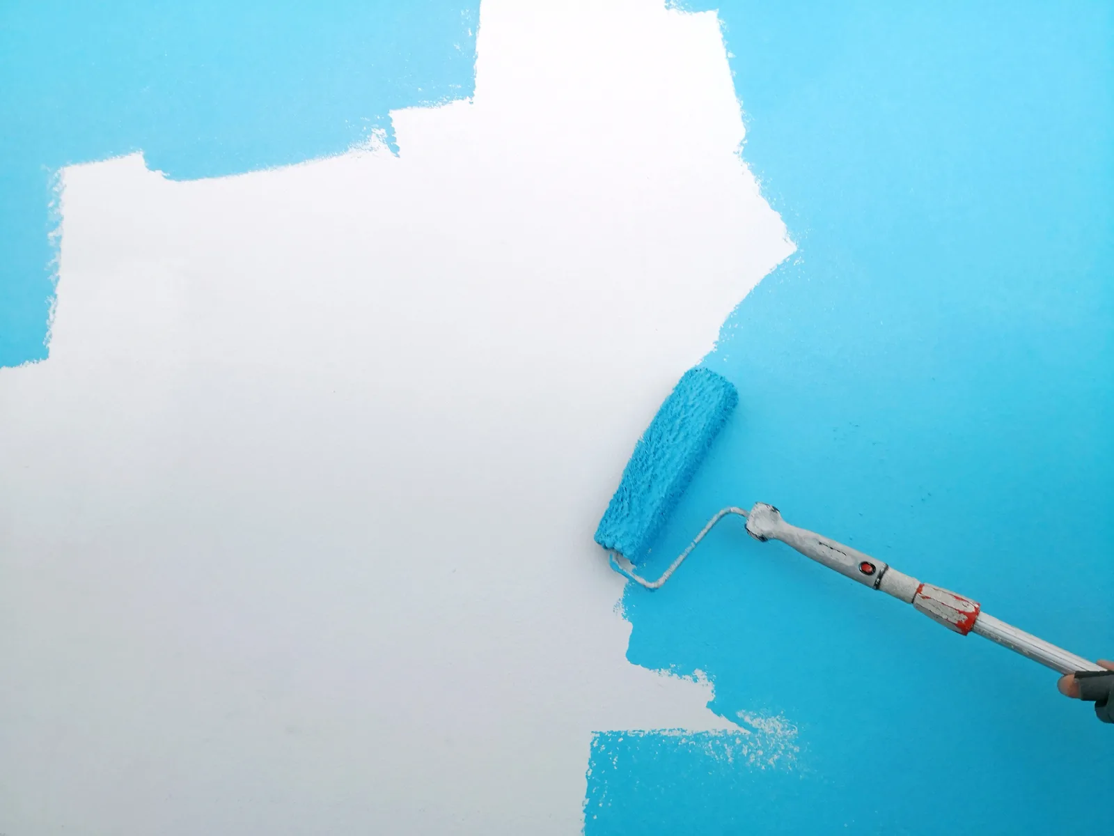 Roller rolling fresh paint onto an interior wall